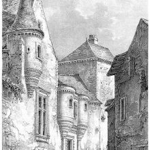 View of a narrow, sloping street showing a convent façade with two oriel windows at the gate