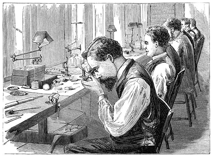 Workshop of a watch factory with men at work sitting on the chairs lining the workbench