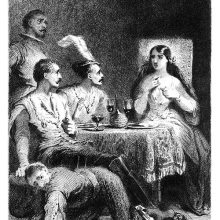 Three men and a woman are sitting at the dinner table as the woman points to herself