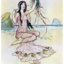A woman is sitting on a beach holding a jellyfish whose tentacles are made of jewelry