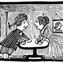 A man and a woman are seen from the side facing each other across a table