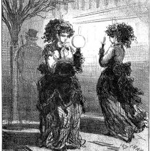 A woman walks in the street carrying an oil lamp and passes another holding a candlestick