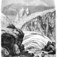 Alpine landscape with rocks, ice sheets, a jagged glacier, and spiky mountain peaks
