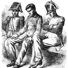 A man is sitting on a bench in the custody of two policemen wearing two-pointed hats