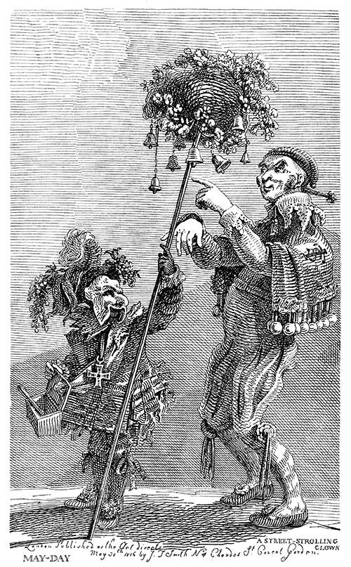 A man and a masked figure holding a basket on a stick are seen wearing fancy clothes