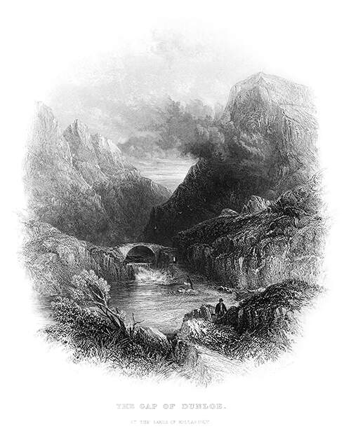 View of the Gap of Dunloe, with a lake in the foreground and mist rising from a mountain