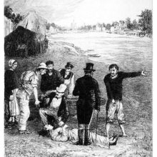 A group of people is having separate discussions around the body of a woman lying on a river bank