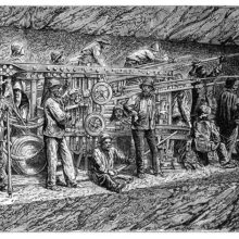 A crew of workers operates a boring machine for the cutting of the Fréjus Rail Tunnel