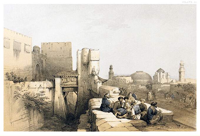 A group of men smoking chibouks is sitting by the walls of the Jerusalem Citadel