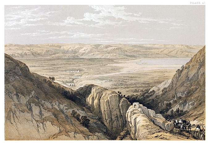 Bird's eye view of the Jordan Valley with a glimpse of the Dead Sea between mountains