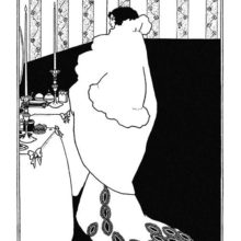 A woman in a roomy coat stands in front of a dressing table on which two candlesticks are standing