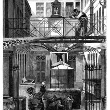 Two men are talking together in a courtyard at the Christofle silver flatware factory