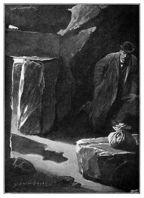 A man crouches at the bottom of a hut as the shadow of a man approaching can be seen on the ground