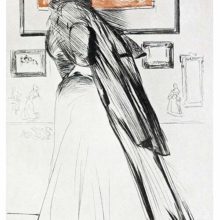 At an exhibition, a woman with her face turned way from the viewer, looks at the pictures