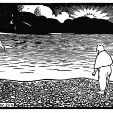 A man stands on a shingle bank while the sun sets behind the hills across the river