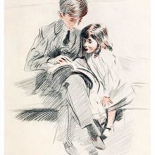A boy is sitting on a couch with his younger sister and shows her something from a book
