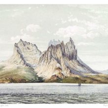 A circular group of mountains with jagged summits slopes down toward the Norwegian Sea