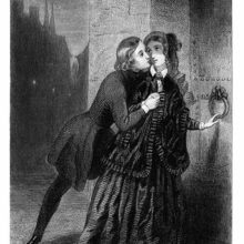 A young man leans forward to kiss a woman as she was about to go through a gate