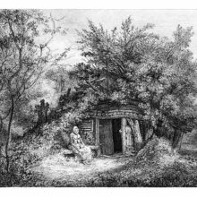 A woman is sitting on a bench outside a cottage merging with the trees and vegetation around