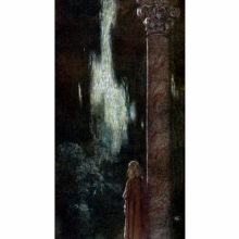 A young woman is seen from the back standing next to a tall column and staring out into the night