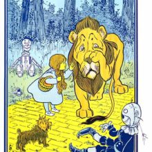 A young girl admonishes a sheepish lion which has been throwing around her companions