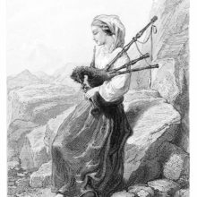 A barefoot woman in country dress is sitting on a rock playing the bagpipe