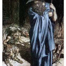 A man wrapped in a cloak stands upright, leaning on a spear as a fretful dwarf talks to him