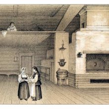 Two women stand in a spacious Russian country interior witha suspended bed area and an oven
