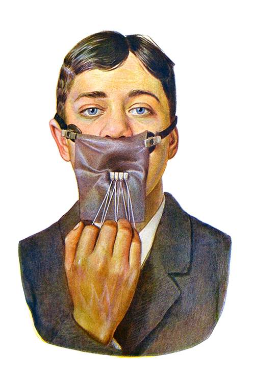 full face view of a young man wearing a rubber dental dam used to isolate four lower incisors