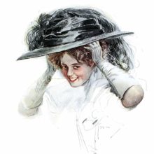 A young woman smiles at the viewer while putting on her hat with her hat pin between her teeth