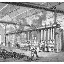 Workers are busy around furnaces in a workshop where the distillation of coal is taking place