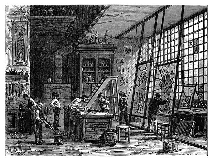 Interior view of a workshop where two painters are working on tall glass panels