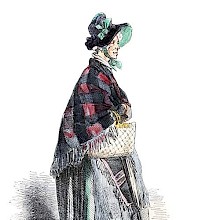 Portrait of an old woman wearing a hat and a shawl and carrying a bag